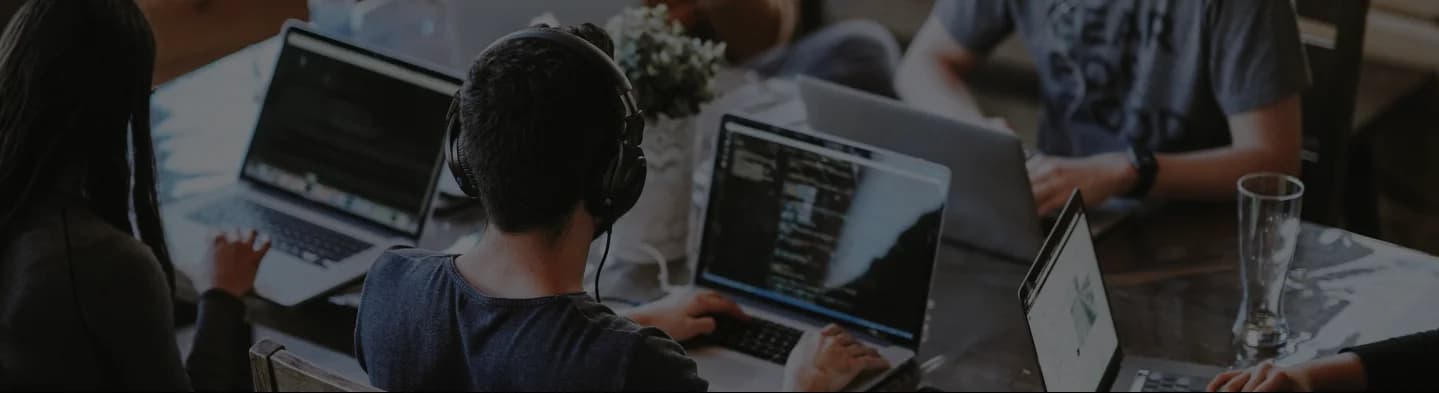 A team of individuals working on laptops at a table, with the Genius Tutors Logo in the background, providing homework assistance. A team of individuals working on laptops at a table, with the Genius Tutors Logo in the background, providing homework assistance.